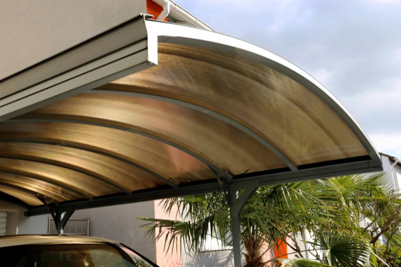 curve roof carport with a car
