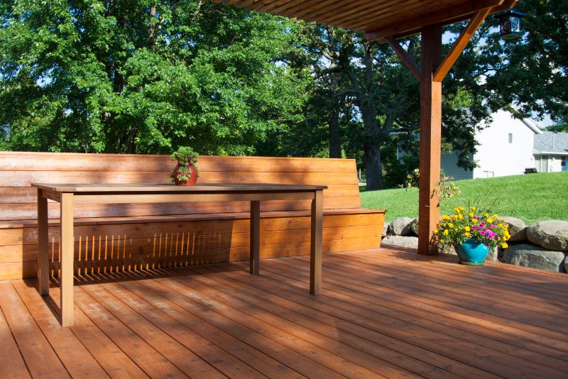 timber deck with a potted plant, table and seating area